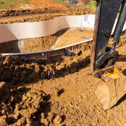 New swimming pool being installed in a back yard